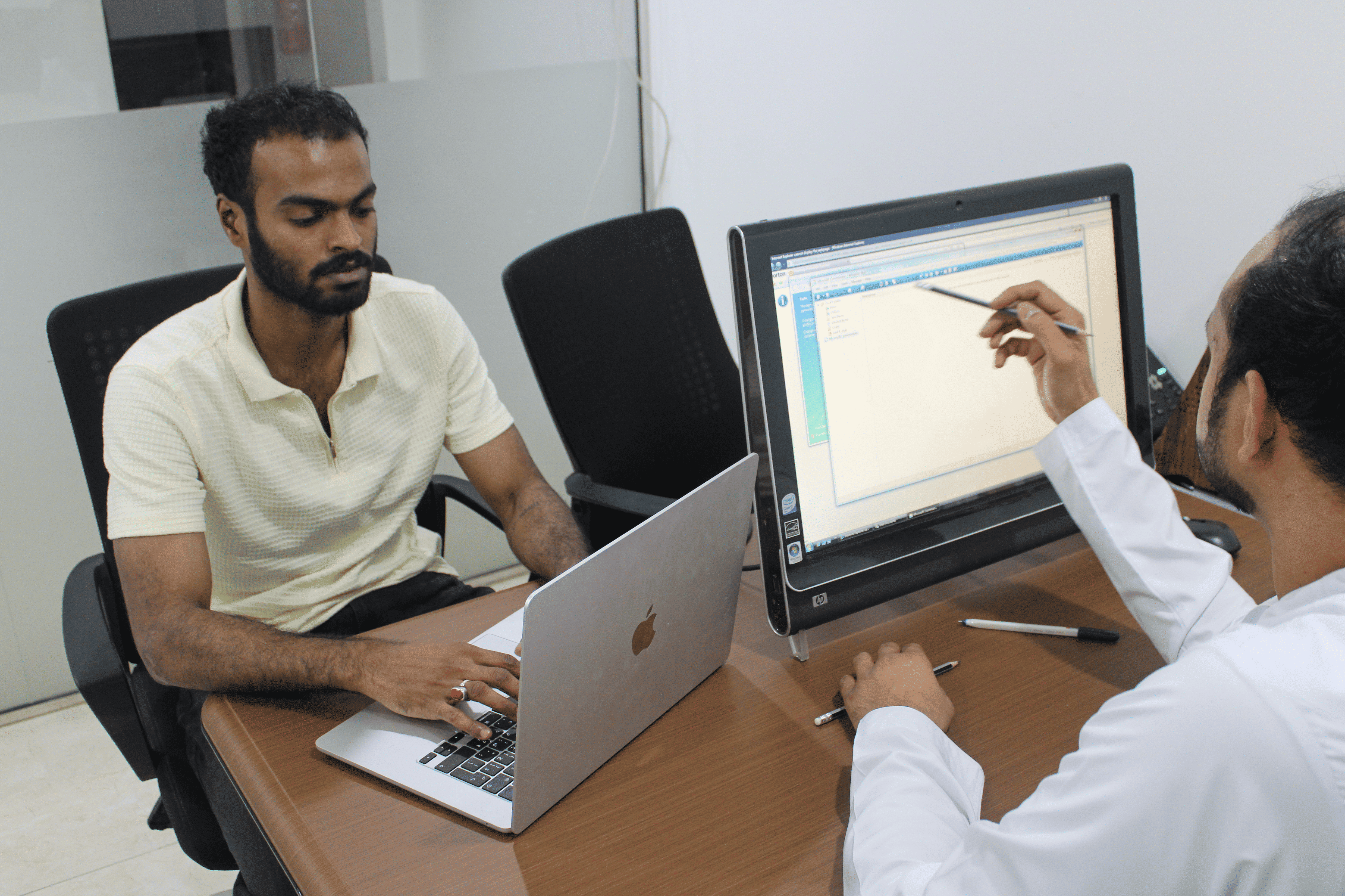 SIGNATURE team collaborating at a desk in the office