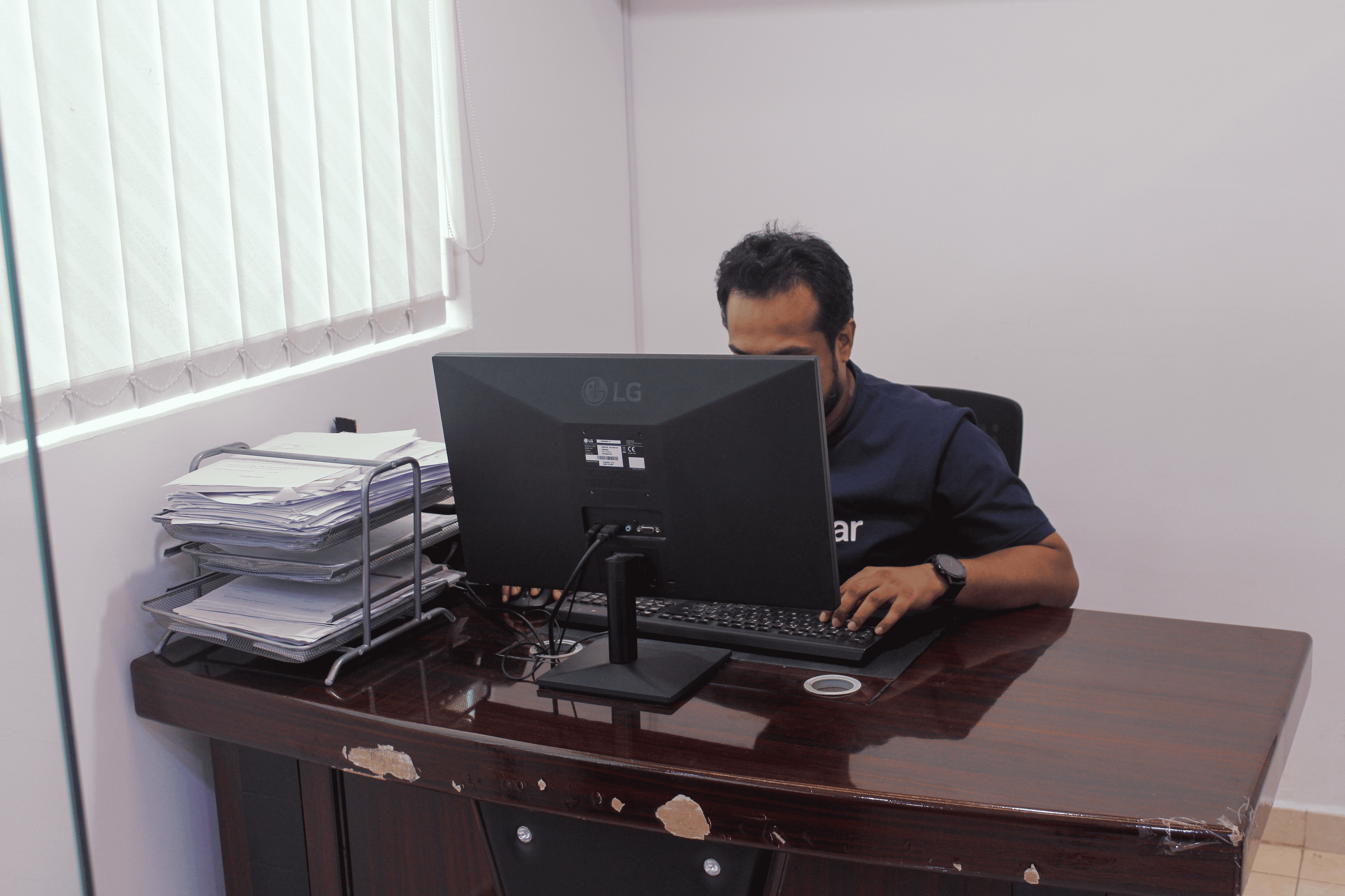 SIGNATURE team member working at a computer in the office